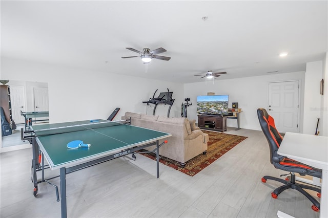 playroom with ceiling fan and light hardwood / wood-style flooring