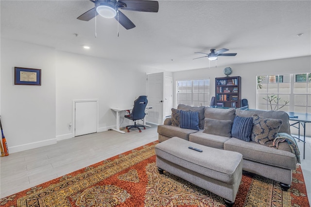 living room featuring a wealth of natural light and ceiling fan