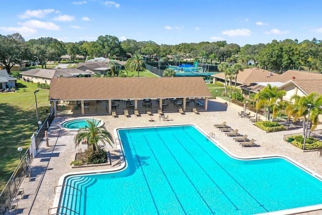 2740 Highlands Blvd Unit D, Palm Harbor, FL 34684 - community pool with a patio area, a community hot tub, and view of wooded area