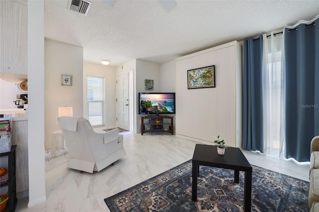 2740 Highlands Blvd Unit D, Palm Harbor, FL 34684 - living area with a textured ceiling and marble look tiles