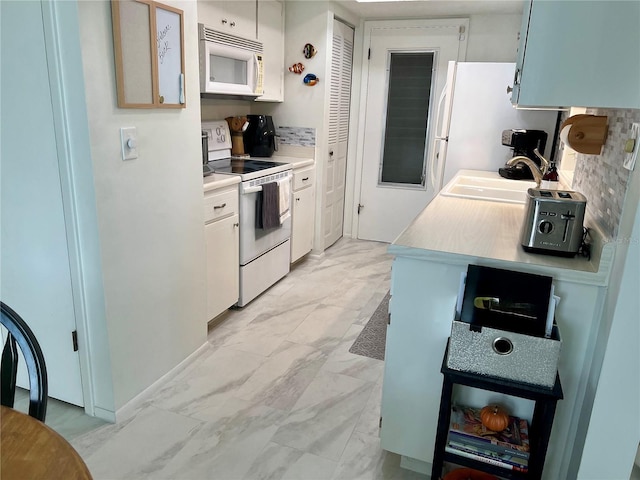 kitchen featuring white cabinets, decorative backsplash, white appliances, and sink