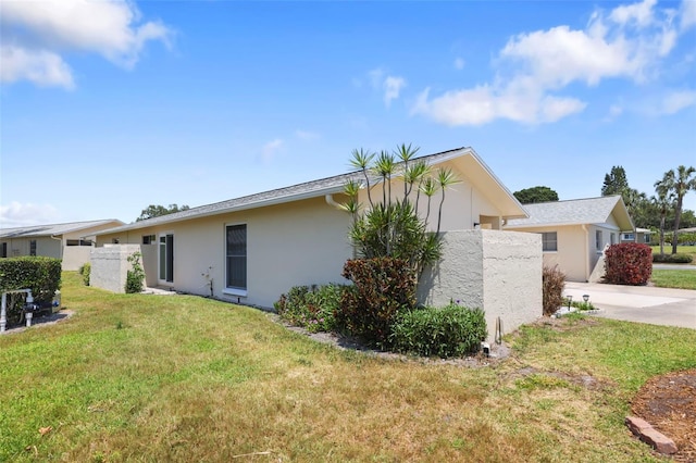 2740 Highlands Blvd Unit D, Palm Harbor, FL 34684 - view of property exterior featuring stucco siding and concrete driveway