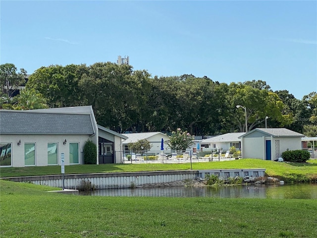 exterior space featuring a lawn and a water view