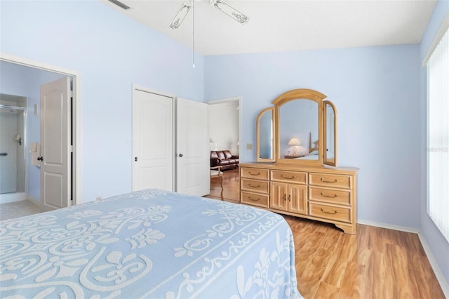 bedroom featuring light hardwood / wood-style flooring, ceiling fan, and lofted ceiling