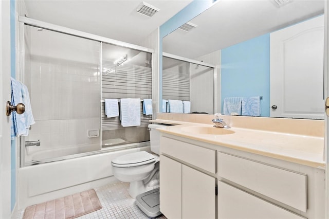 full bathroom with toilet, vanity, tile patterned floors, and enclosed tub / shower combo