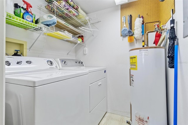 clothes washing area with washing machine and dryer and water heater