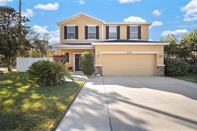 view of front facade featuring a front lawn and a garage