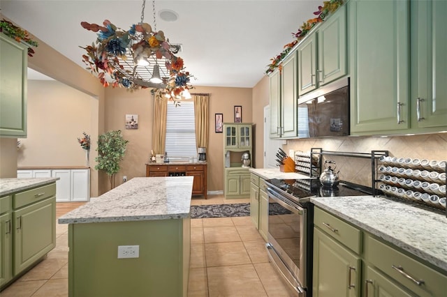 kitchen featuring stainless steel electric range oven, a kitchen island, light tile patterned floors, and green cabinetry