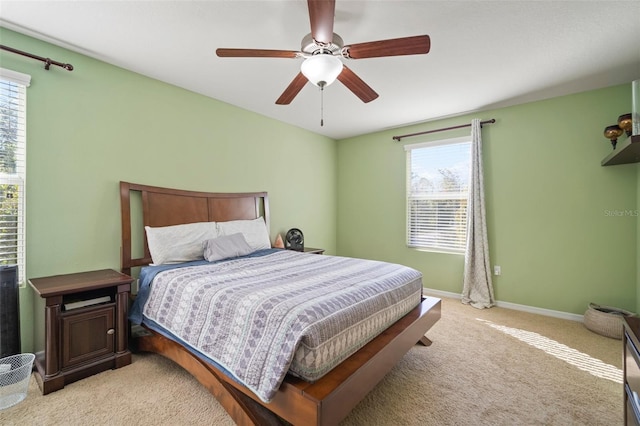 carpeted bedroom with multiple windows and ceiling fan