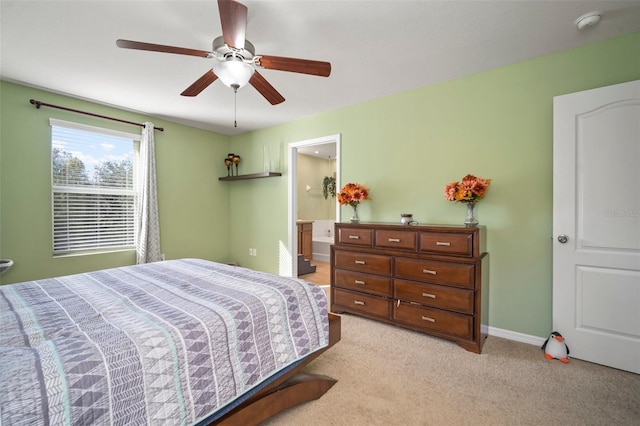 carpeted bedroom featuring ensuite bath and ceiling fan