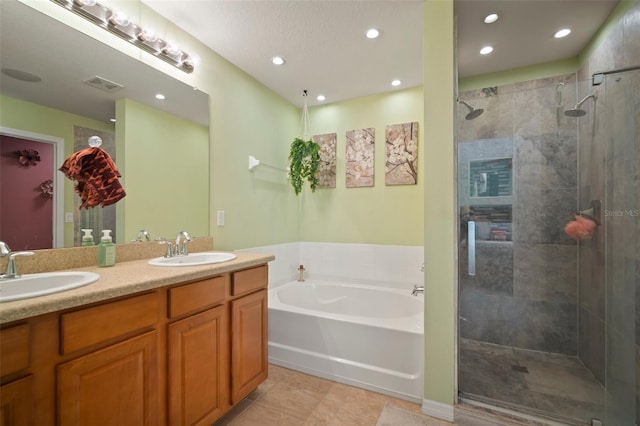 bathroom featuring tile patterned floors, vanity, and separate shower and tub