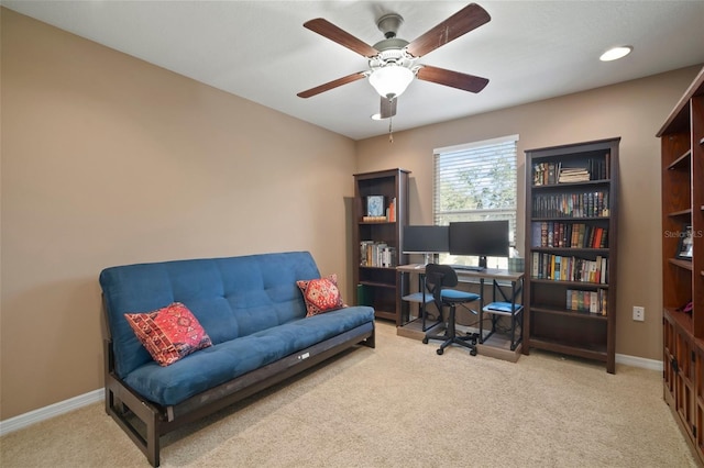 carpeted home office with ceiling fan