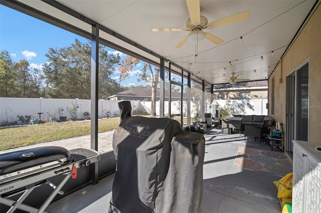 sunroom featuring ceiling fan