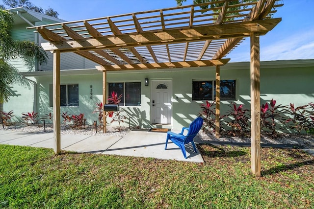 back of property with a pergola and a yard