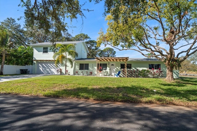 view of front of house with a garage and a front lawn