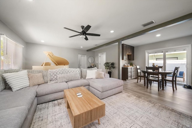 living room featuring light wood-type flooring and ceiling fan