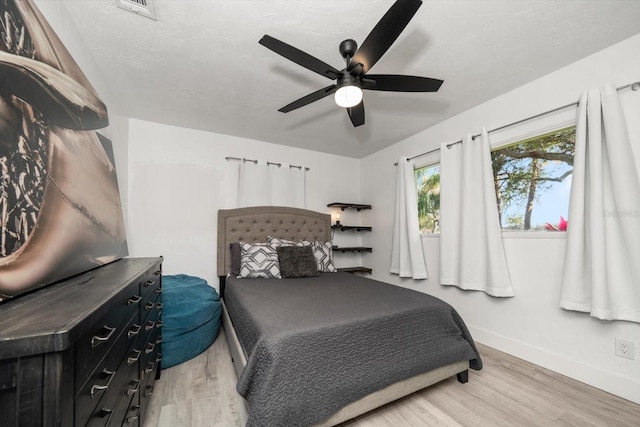 bedroom featuring wood-type flooring, a textured ceiling, and ceiling fan