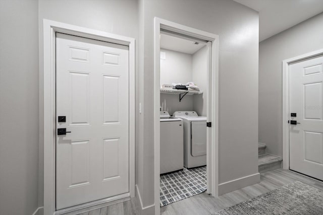 washroom featuring independent washer and dryer and light wood-type flooring