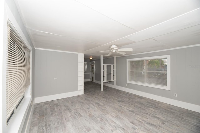 unfurnished living room featuring hardwood / wood-style floors, ceiling fan, and ornamental molding