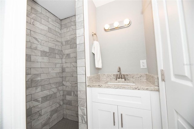 bathroom featuring vanity and a tile shower