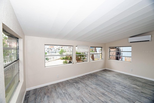 unfurnished sunroom with a wall mounted AC and vaulted ceiling