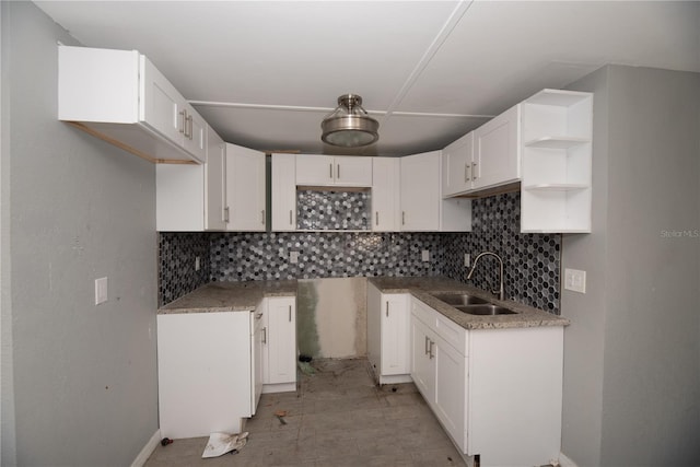 kitchen with white cabinets, tasteful backsplash, and sink