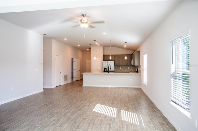 unfurnished living room featuring ceiling fan, light hardwood / wood-style floors, and lofted ceiling