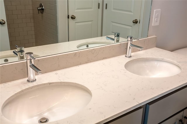 bathroom with vanity and tiled shower