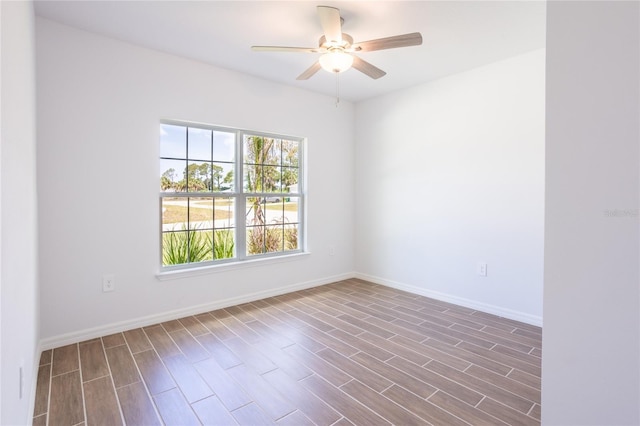 spare room featuring ceiling fan and dark wood-type flooring