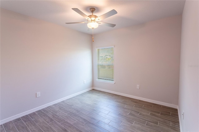 unfurnished room with dark hardwood / wood-style flooring and ceiling fan