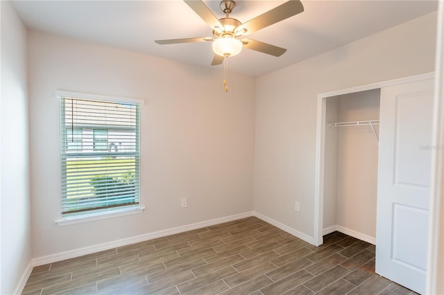 unfurnished bedroom with ceiling fan and a closet