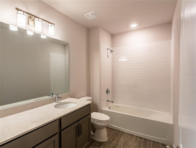 full bathroom featuring vanity, toilet, and tiled shower / bath