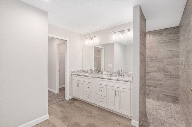 5421 N Nakoma Dr, Beverly Hills, FL 34465 - full bath featuring double vanity, a spacious closet, a walk in shower, and wood finished floors