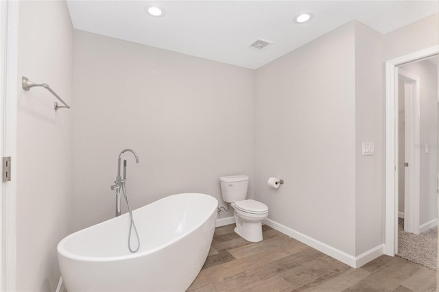 5421 N Nakoma Dr, Beverly Hills, FL 34465 - bathroom with a freestanding tub, wood finished floors, and recessed lighting