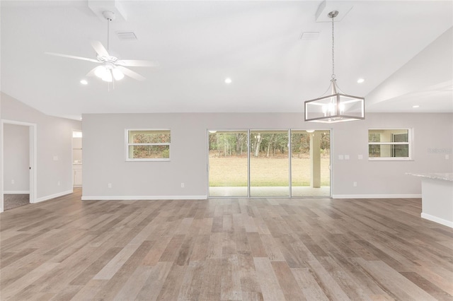 5421 N Nakoma Dr, Beverly Hills, FL 34465 - unfurnished living room with high vaulted ceiling, a ceiling fan, recessed lighting, light wood-type flooring, and a chandelier