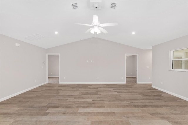 spare room with ceiling fan, light hardwood / wood-style flooring, and vaulted ceiling