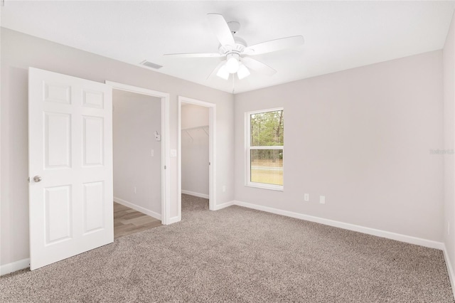 5421 N Nakoma Dr, Beverly Hills, FL 34465 - unfurnished bedroom with light colored carpet, a spacious closet, a closet, and a ceiling fan