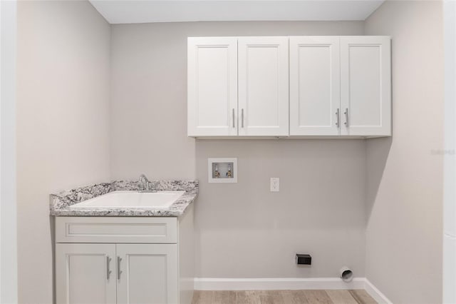 laundry area featuring sink, cabinets, electric dryer hookup, hookup for a washing machine, and light wood-type flooring