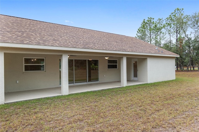 rear view of property with a lawn and a patio