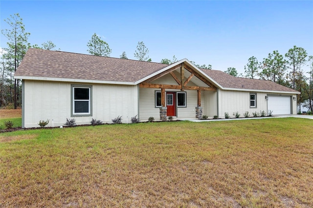 single story home with a front yard and a garage