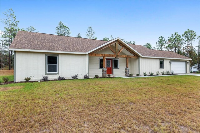 5421 N Nakoma Dr, Beverly Hills, FL 34465 - view of front of property featuring a garage, a front yard, driveway, and a shingled roof