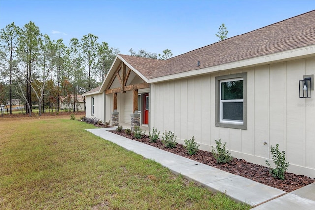 5421 N Nakoma Dr, Beverly Hills, FL 34465 - view of home's exterior with roof with shingles, a lawn, and board and batten siding