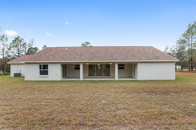 5421 N Nakoma Dr, Beverly Hills, FL 34465 - rear view of house with a patio, a yard, a shingled roof, and stucco siding