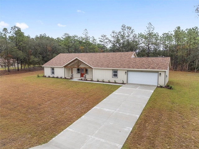 5421 N Nakoma Dr, Beverly Hills, FL 34465 - view of front of home with a garage, driveway, a front lawn, and a porch