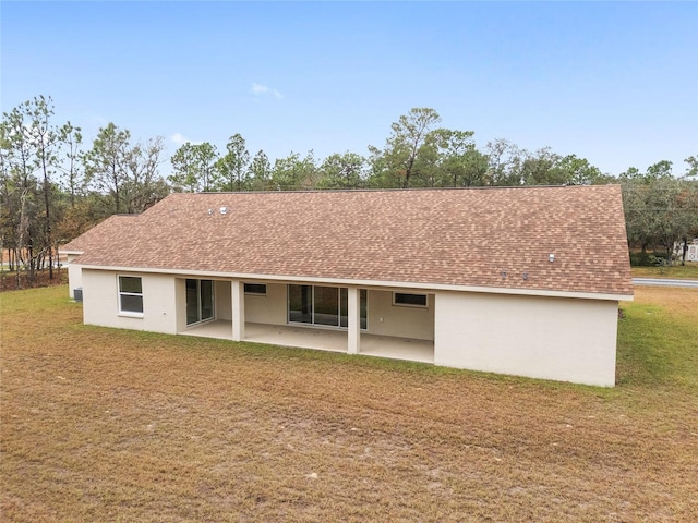 rear view of house featuring a yard and a patio