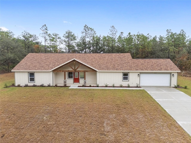 ranch-style house featuring covered porch, a front yard, and a garage