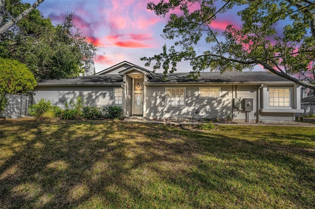 ranch-style home featuring a yard