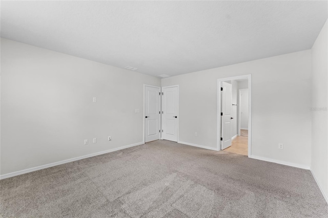 empty room featuring light colored carpet