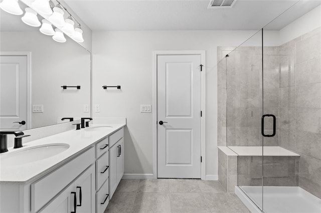 bathroom with tile patterned floors, a shower with door, and vanity