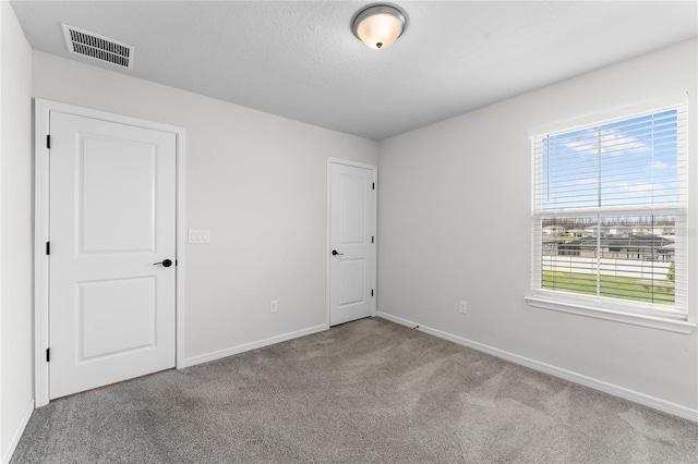 unfurnished room with light carpet and a wealth of natural light